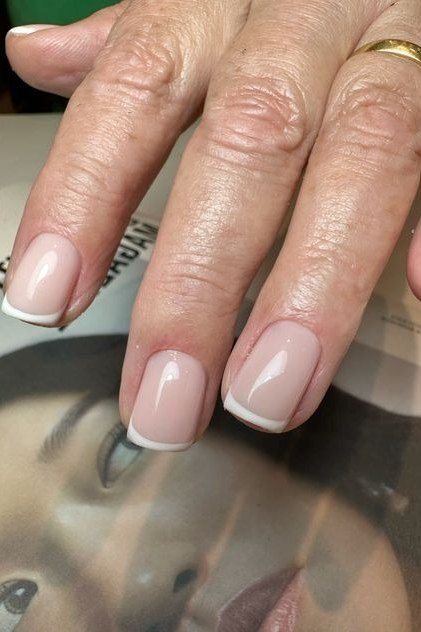timeless french manicure on older hands for older women