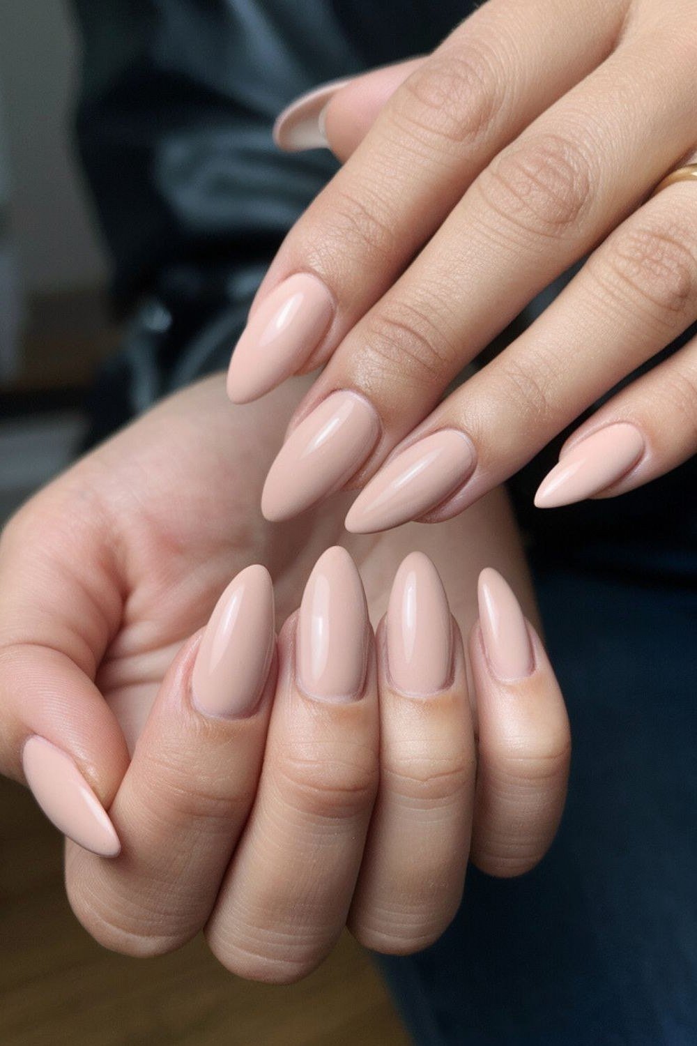 Almond nude nails with two hands shown