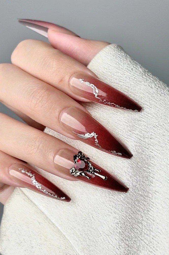 Burgundy ombre nails with rhinestone heart accent for women over 50