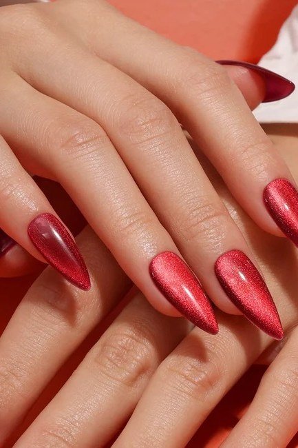 Red shimmer stiletto, burgundy fall nail idea for women over 60