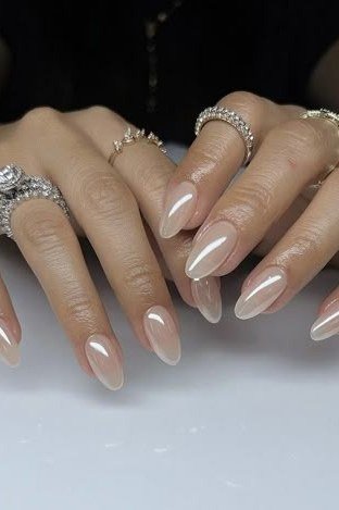 Pearly white almond nails with rings for women over 50