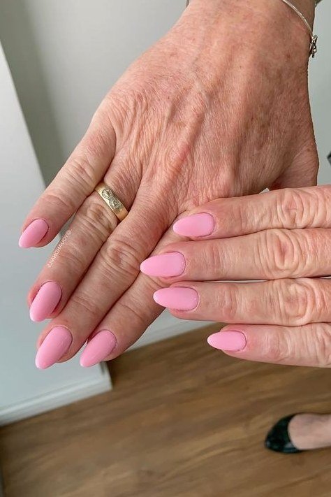 pink nails with a dainty ring for older women