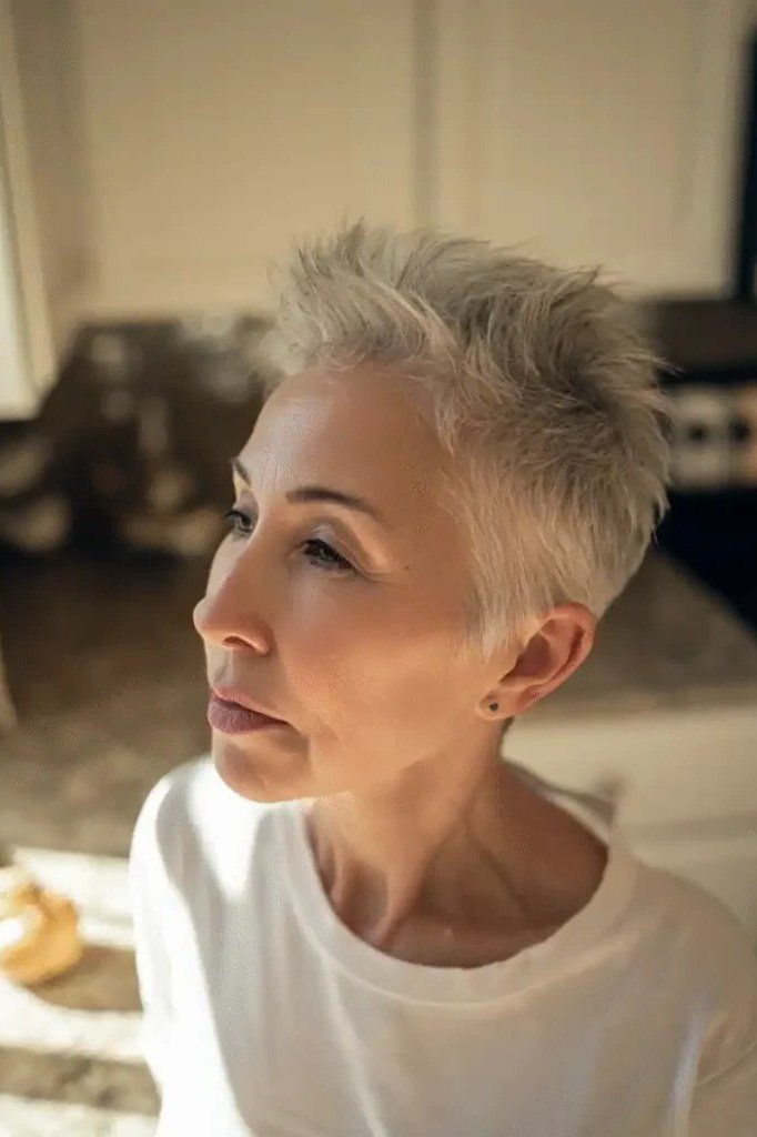 Blonde spiky textured pixie, piecey crown, three-quarter view for women over 60