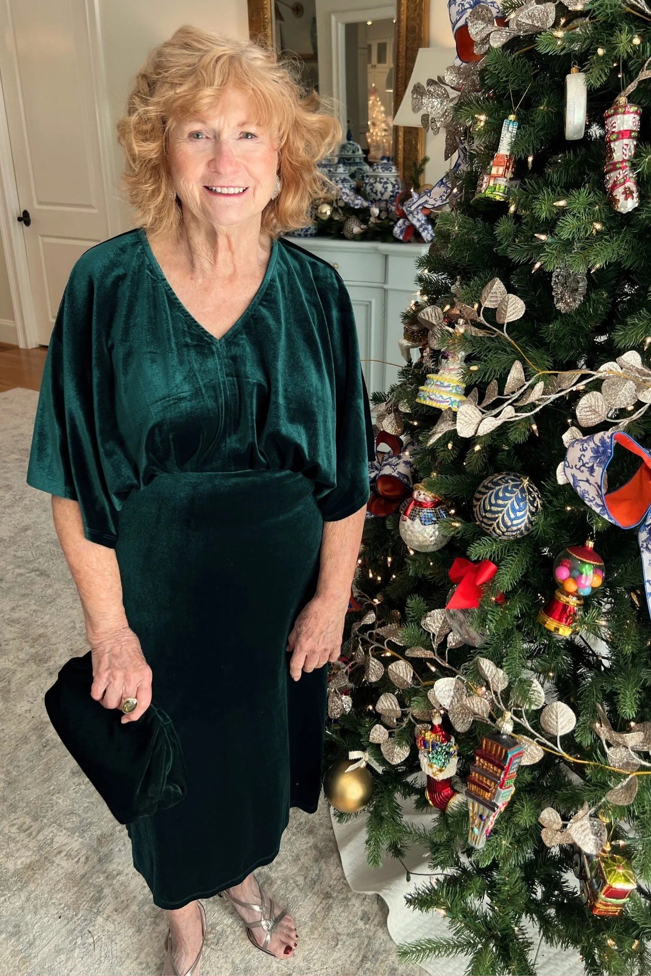 dark green velvet dress by the christmas tree for women over 60