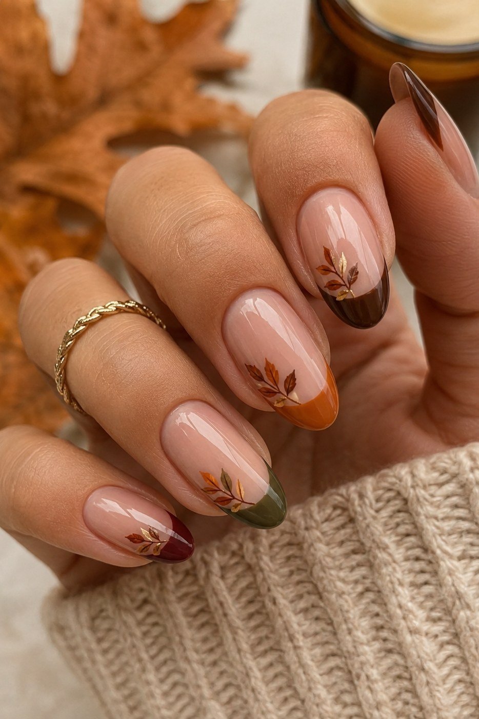 Nude with autumn ombre french tips in orange and brown with leaf art, almond shape, medium length, glossy, fall nail color for women over 40