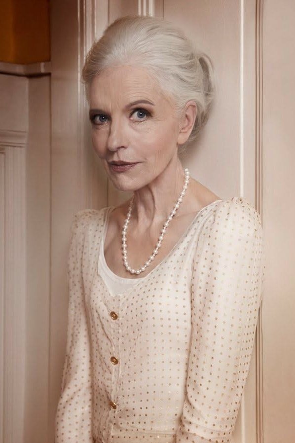 Cream cardigan with pearl necklace for women over 70