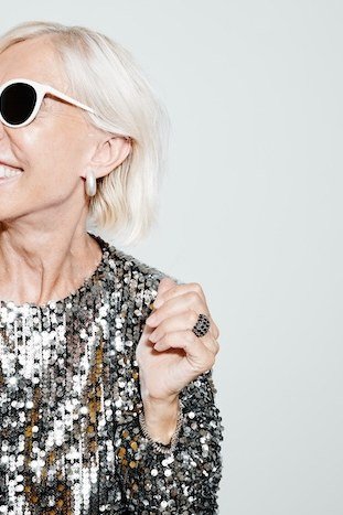 holiday evening outfit for women over 60: gold sequin top with sunglasses