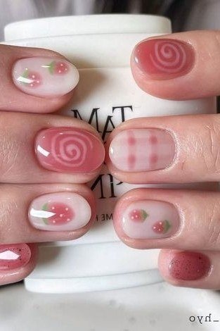 Milky pink oval nails with strawberry swirl and checkered art