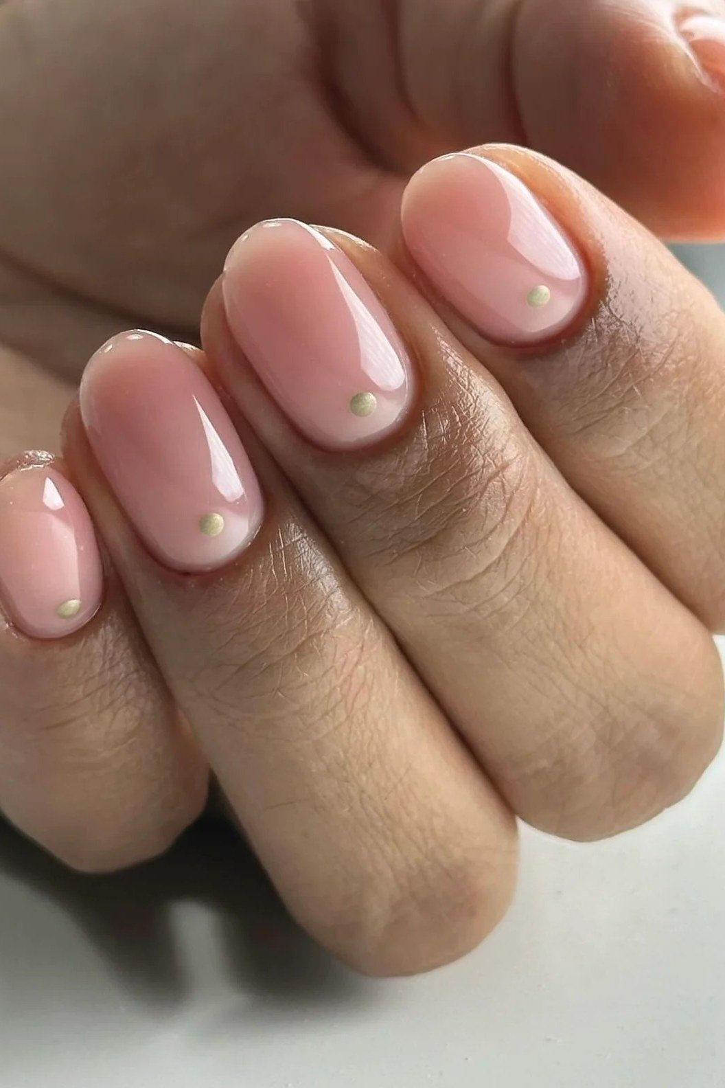 sheer pink short nails with gold dot accent