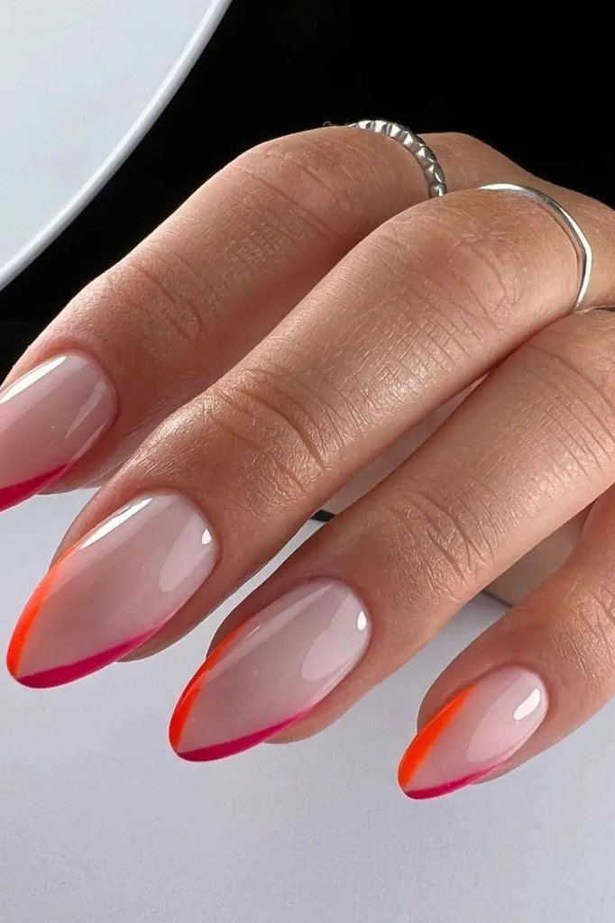 Pink Ombre French on Almond Nails - A milky base fades into hot pink and coral ombre tips on these medium almond nails.