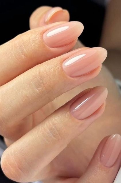 Glossy nude pink almond nails for women over 50