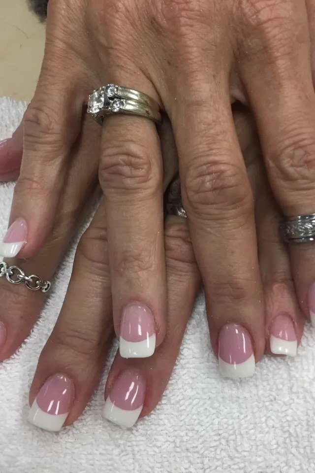 French manicure with rings on mature hands