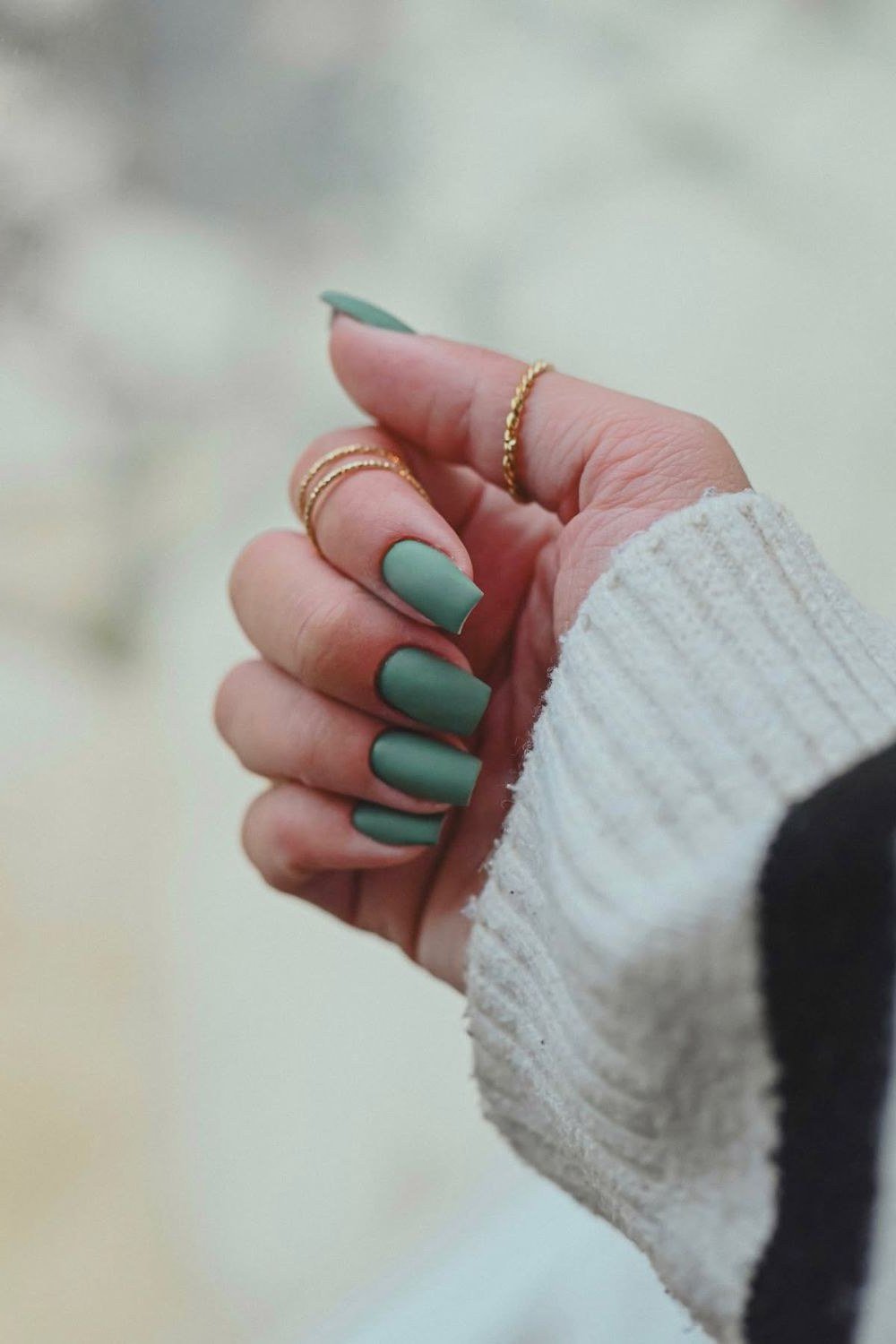 sage green nails with cream sweater