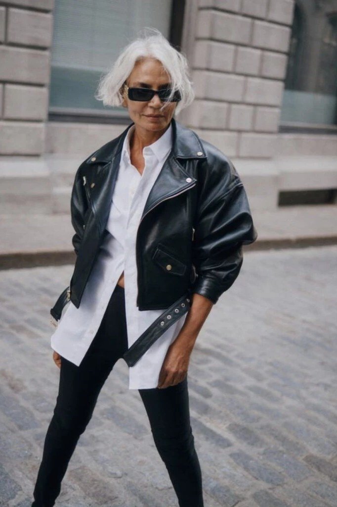 Black moto jacket with white shirt and black pants fall outfit idea for women over 60