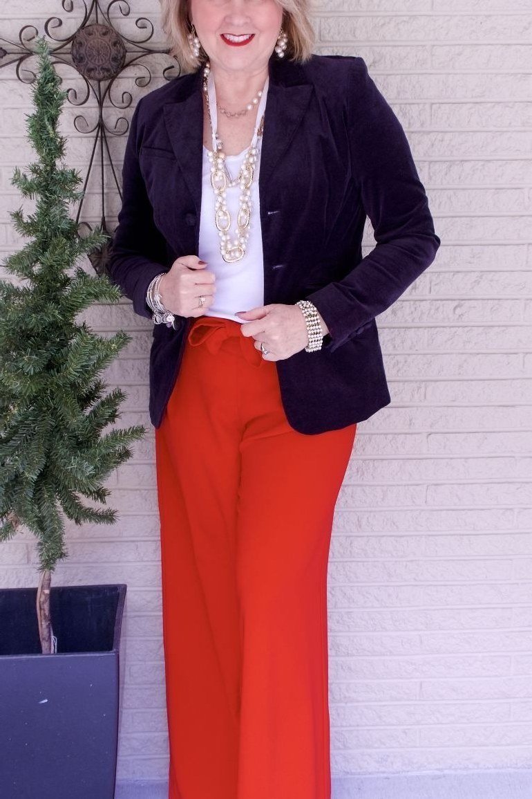 Navy velvet blazer with red trousers for women over 50, fall date night outfit