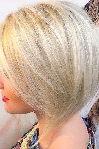 Platinum angled bob with deep side part, woman, side view - trendy short haircut for older women with fine hair