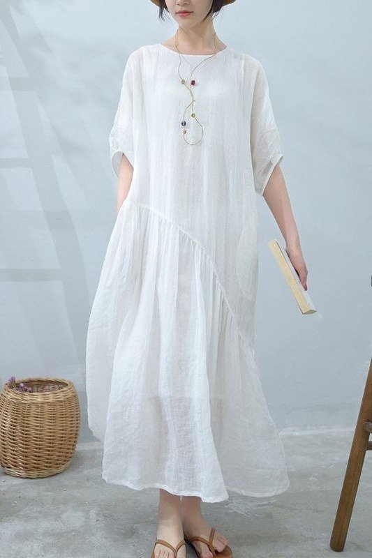 White tiered maxi dress with woven basket, bright interior for women over 60