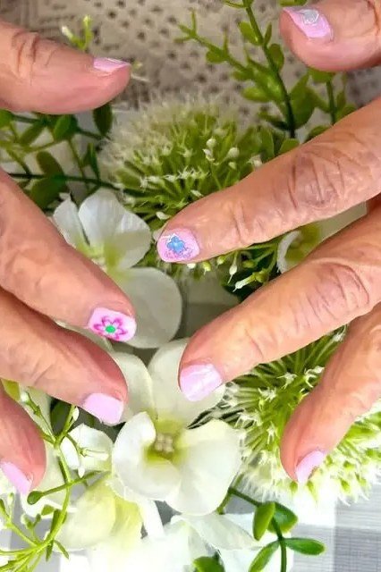 Nail art design for women over 60: pastel floral nail art on older hands