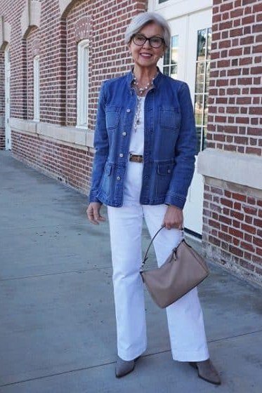 Woman over 50 wearing denim jacket with white tee and white jeans, everyday casual outfit idea