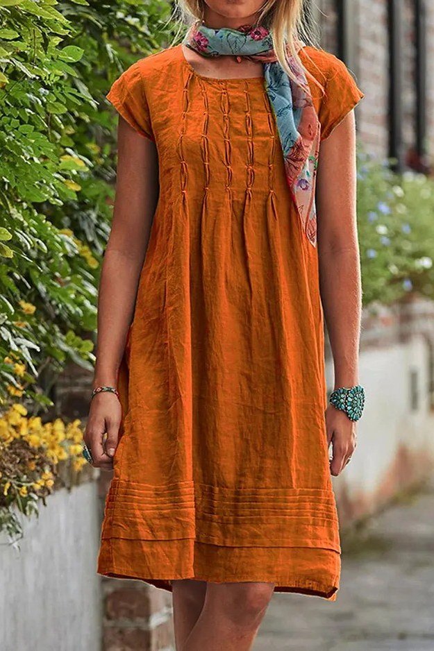 Breezy summer dress for women over 60: teal floral maxi with straw tote
