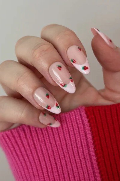 Sheer pinky-red jelly glaze on almond nails