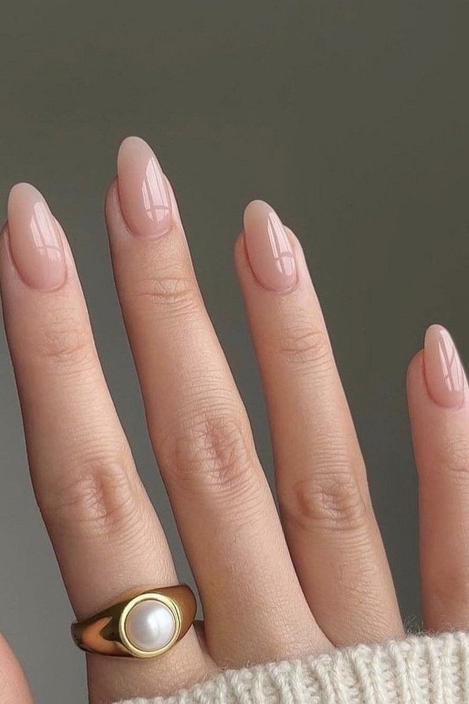 Pale nude almond nails with pearl ring for women over 50