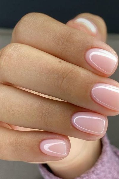 Milky white pink almond nails close-up