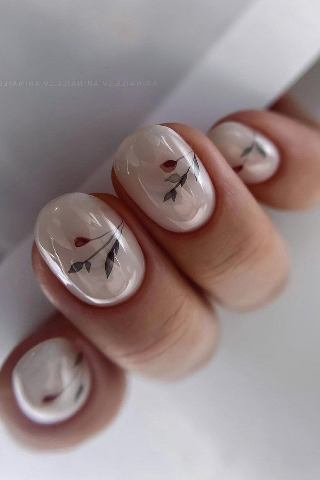 Milky white nails with delicate dark leaf nail art