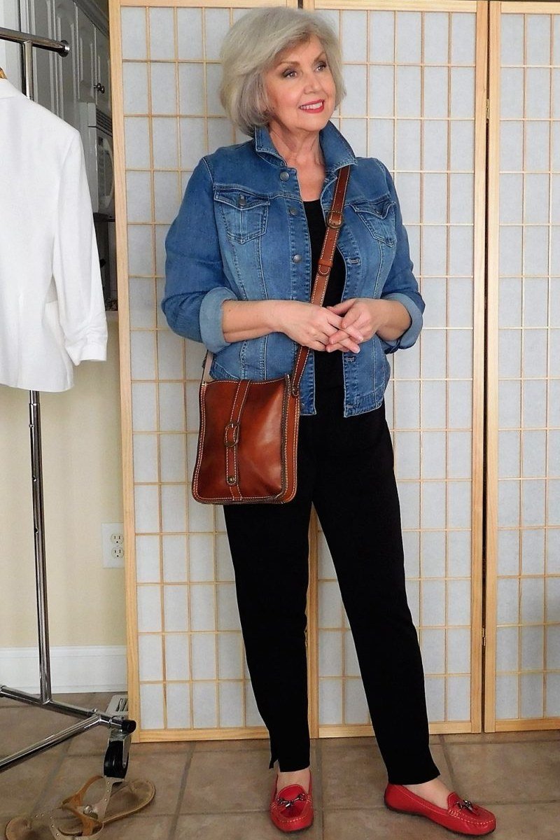 Woman over 50 wearing denim jacket with black pants and red flats, everyday casual outfit idea