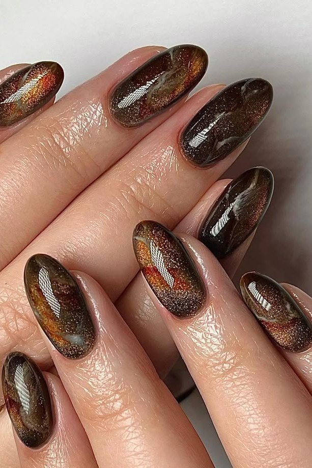 35. Tortoiseshell Cat Eye Nails - Thanksgiving nail art idea for women over 50