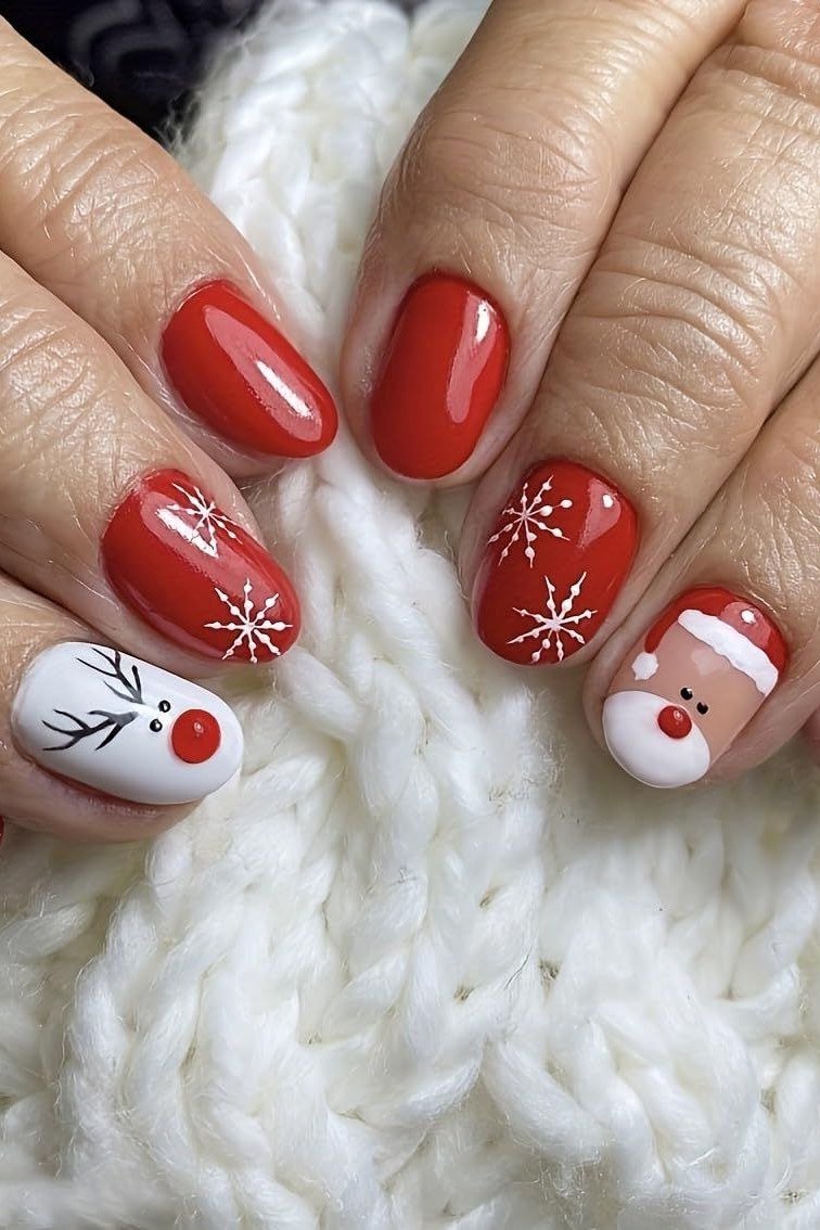 Red nails with Santa and reindeer face art - classy Christmas nail idea for women over 70