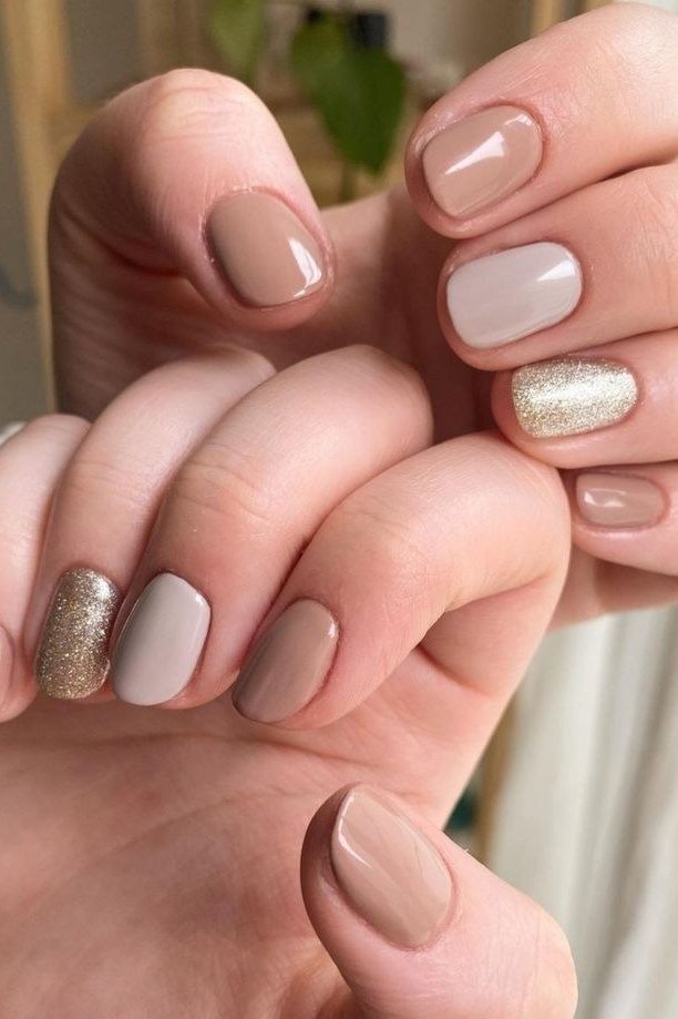 taupe short nails with champagne glitter accents