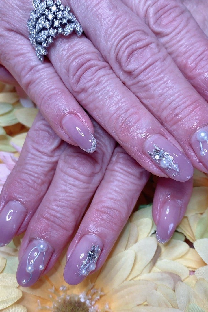 Lilac almond nails with rhinestone accents