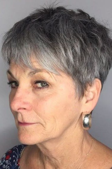 Grey feathered pixie, side-swept layers, three-quarter view for women over 60