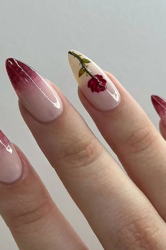 Burgundy ombre stiletto nails with floral accent for women over 50