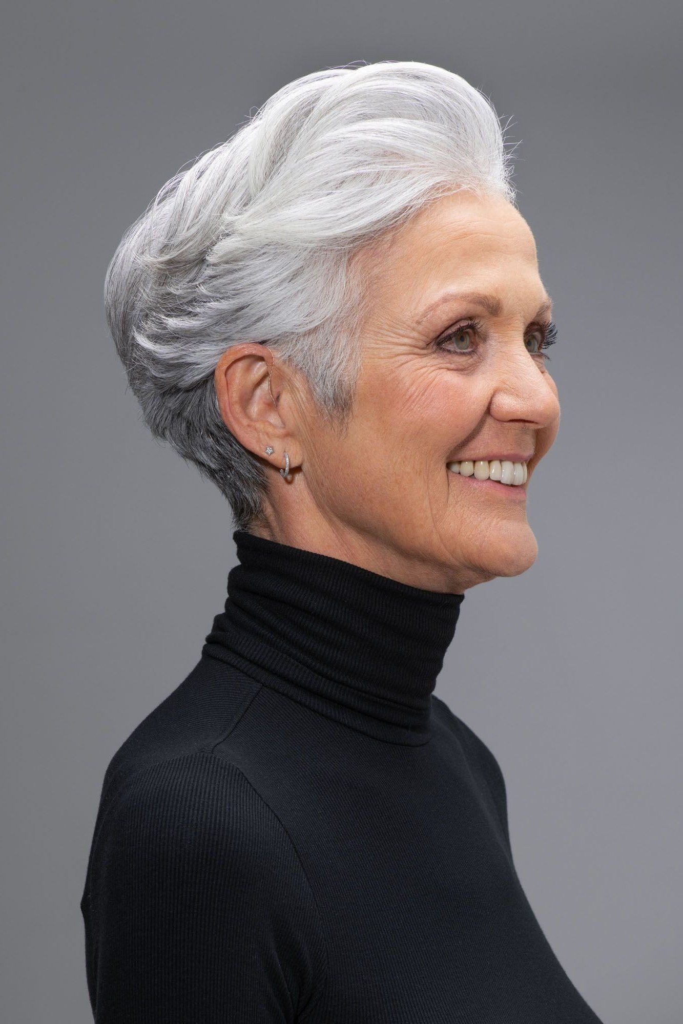 Smiling white wispy pixie with turtleneck and soft layers