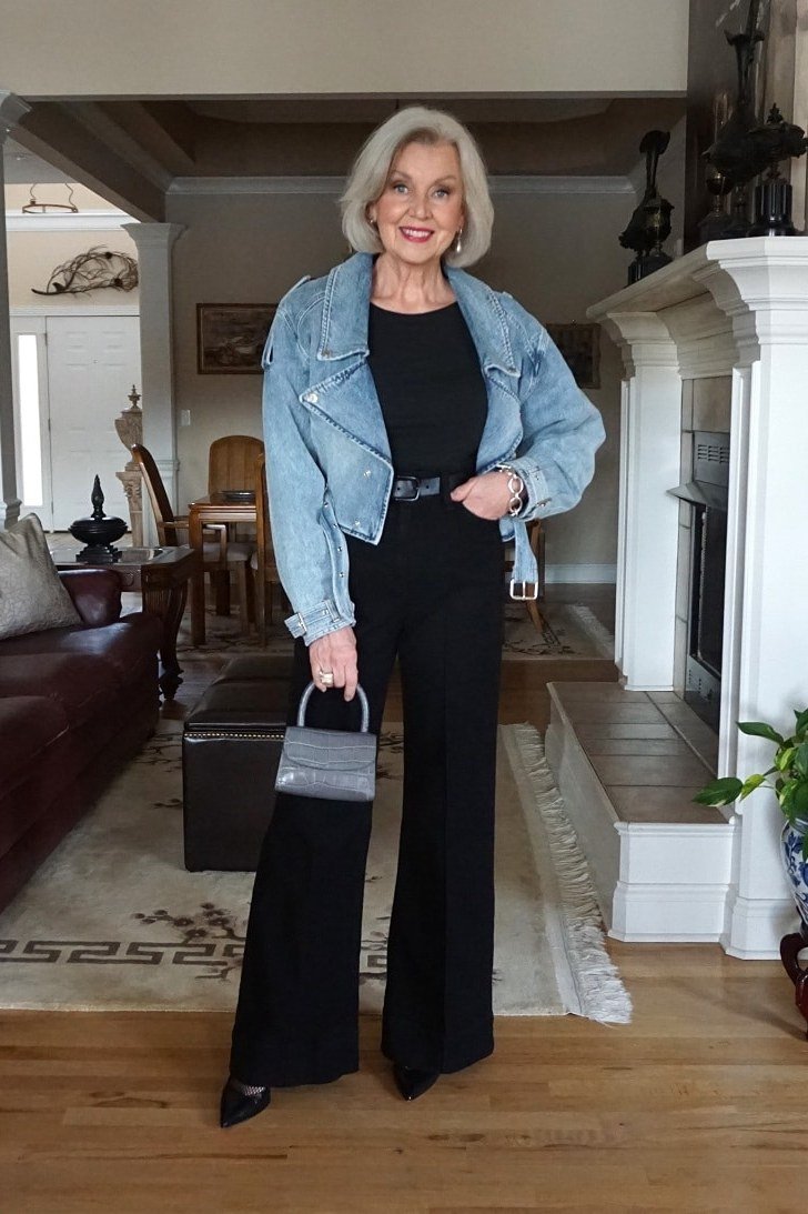 Woman over 50 wearing denim jacket with black wide-leg pants, everyday casual outfit idea