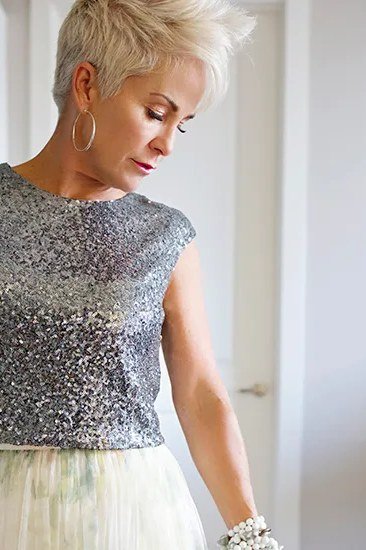holiday evening outfit for women over 60: silver sequin top with ivory tulle skirt
