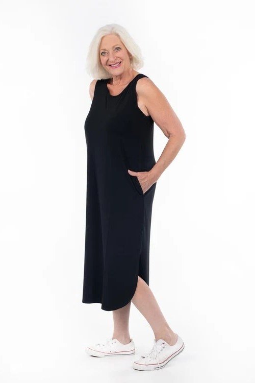 Black sleeveless midi dress with white sneakers for women over 60