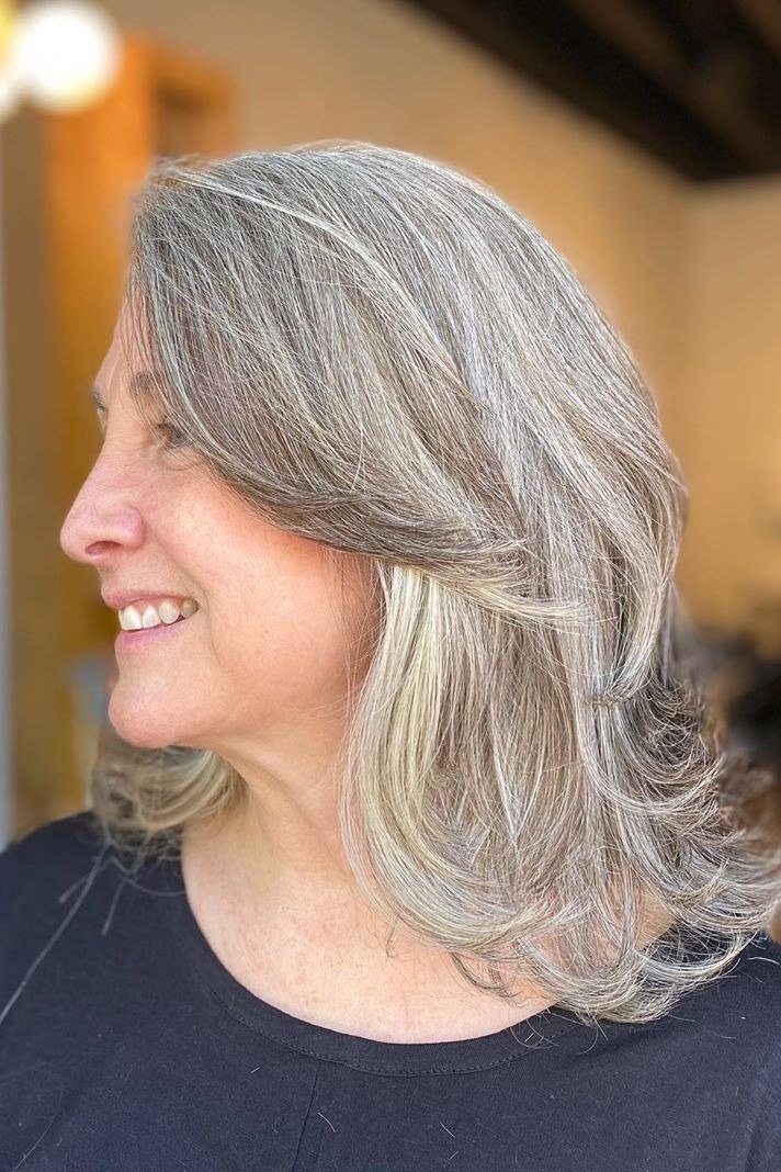 Long silver layered haircut for women over 60, side view