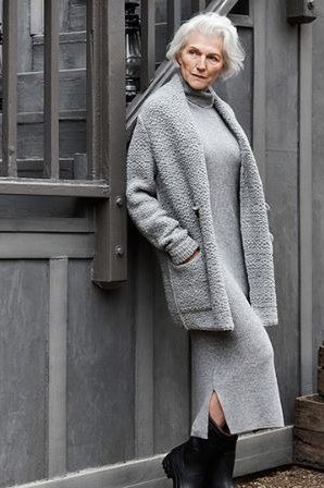 Long grey wool coat over grey dress with black boots, minimal October outfit over 50