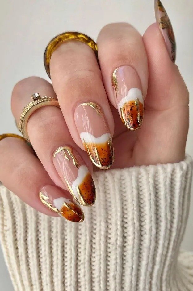Caramel ombre with white tips and gold leaf, elegant fall nail design for women over 40