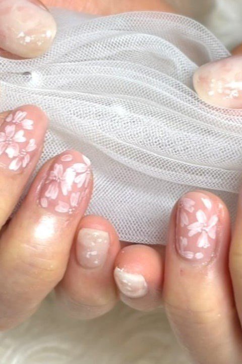 Nail art design for women over 60: nude nails with white dot florals