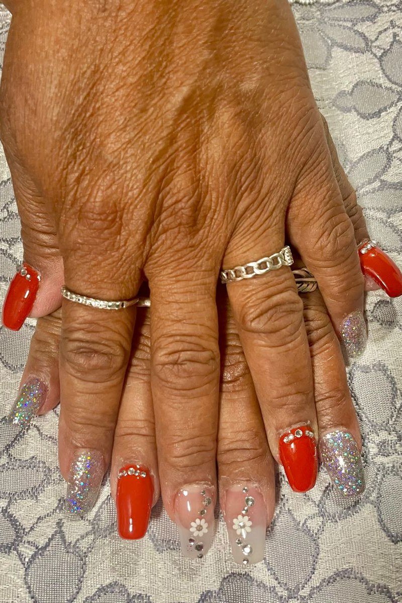 Cherry red nails with silver glitter accents