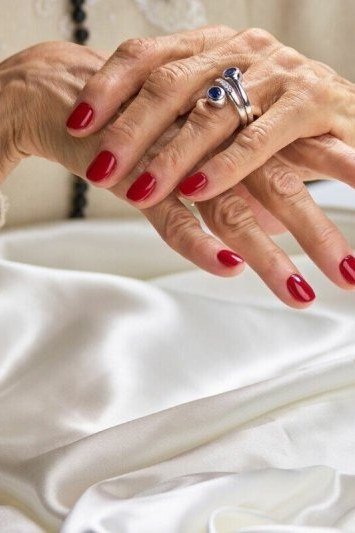 luxurious red nails on soft silk for older women
