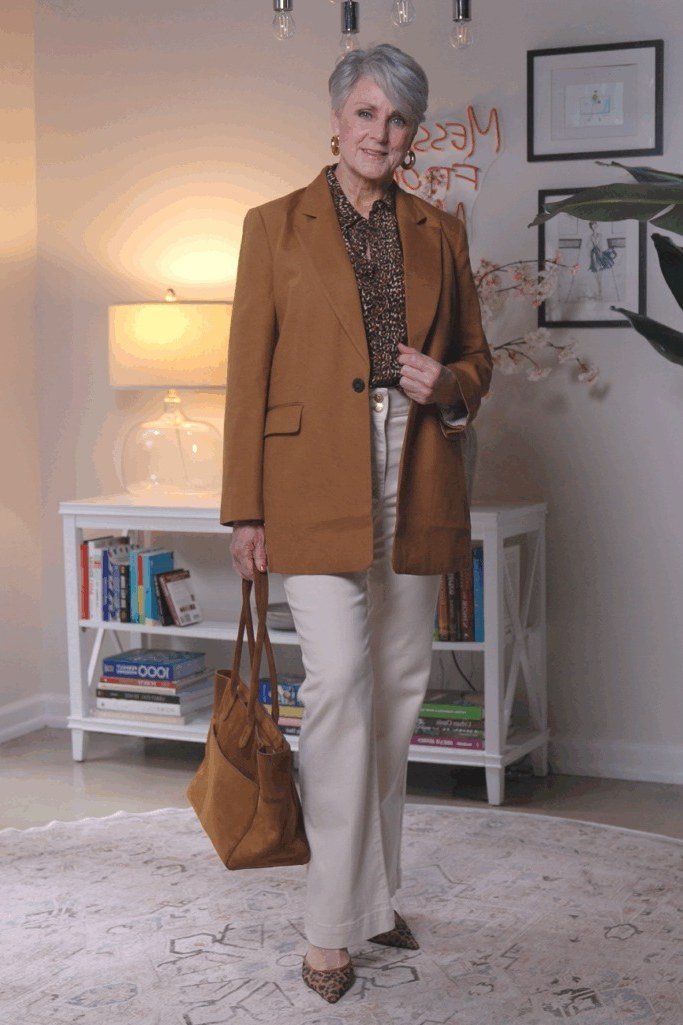Brown blazer with patterned blouse and cream pants for women over 60