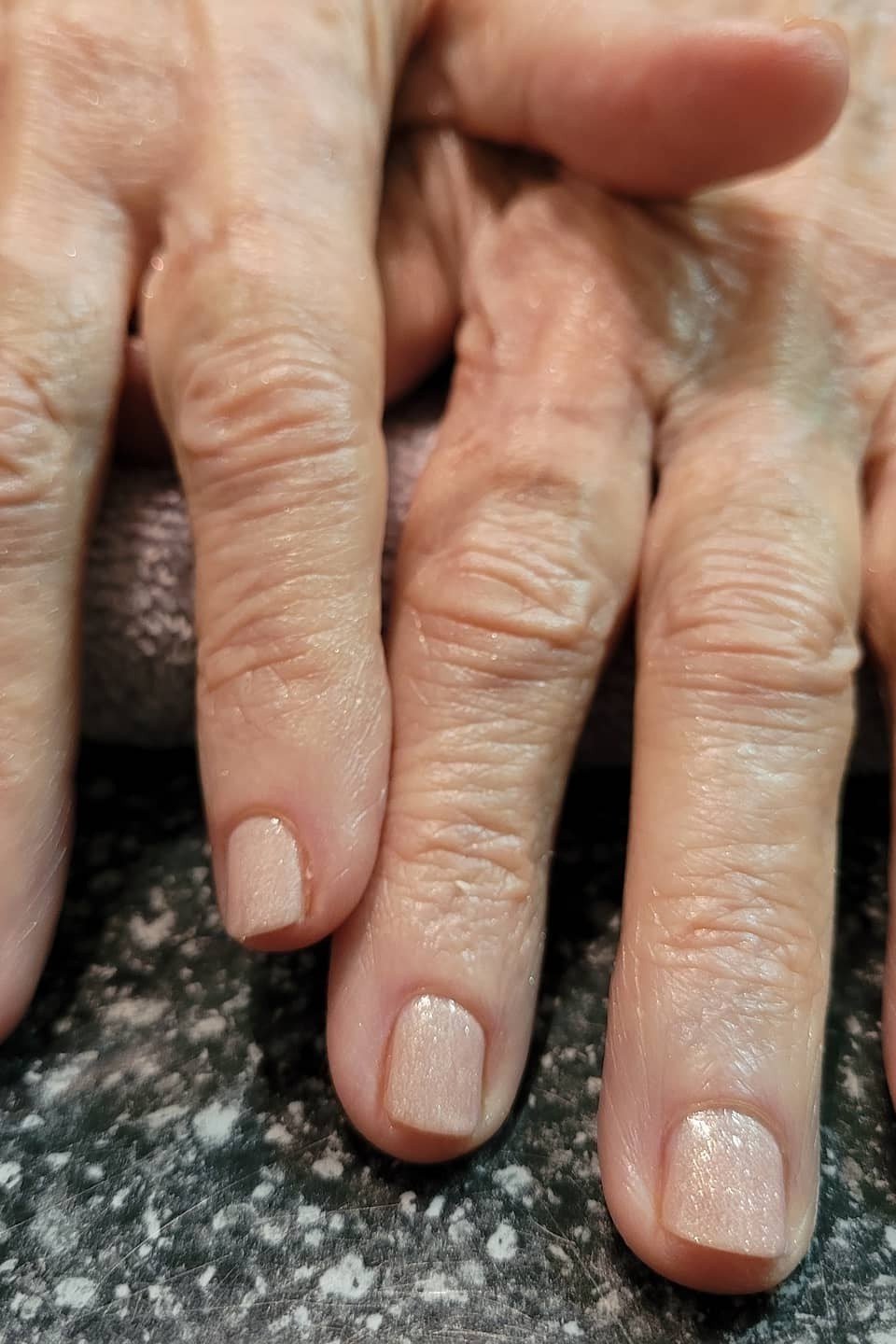 Sheer nude short nails on elderly hands