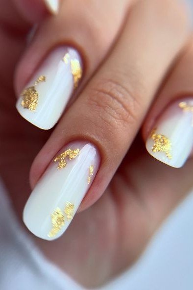 Milky white nails with abstract gold foil accents