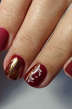 Glossy burgundy with gold foil art, burgundy fall nail idea for women over 60