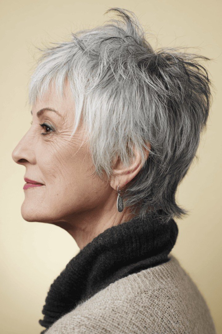 White wispy pixie side profile with black turtleneck
